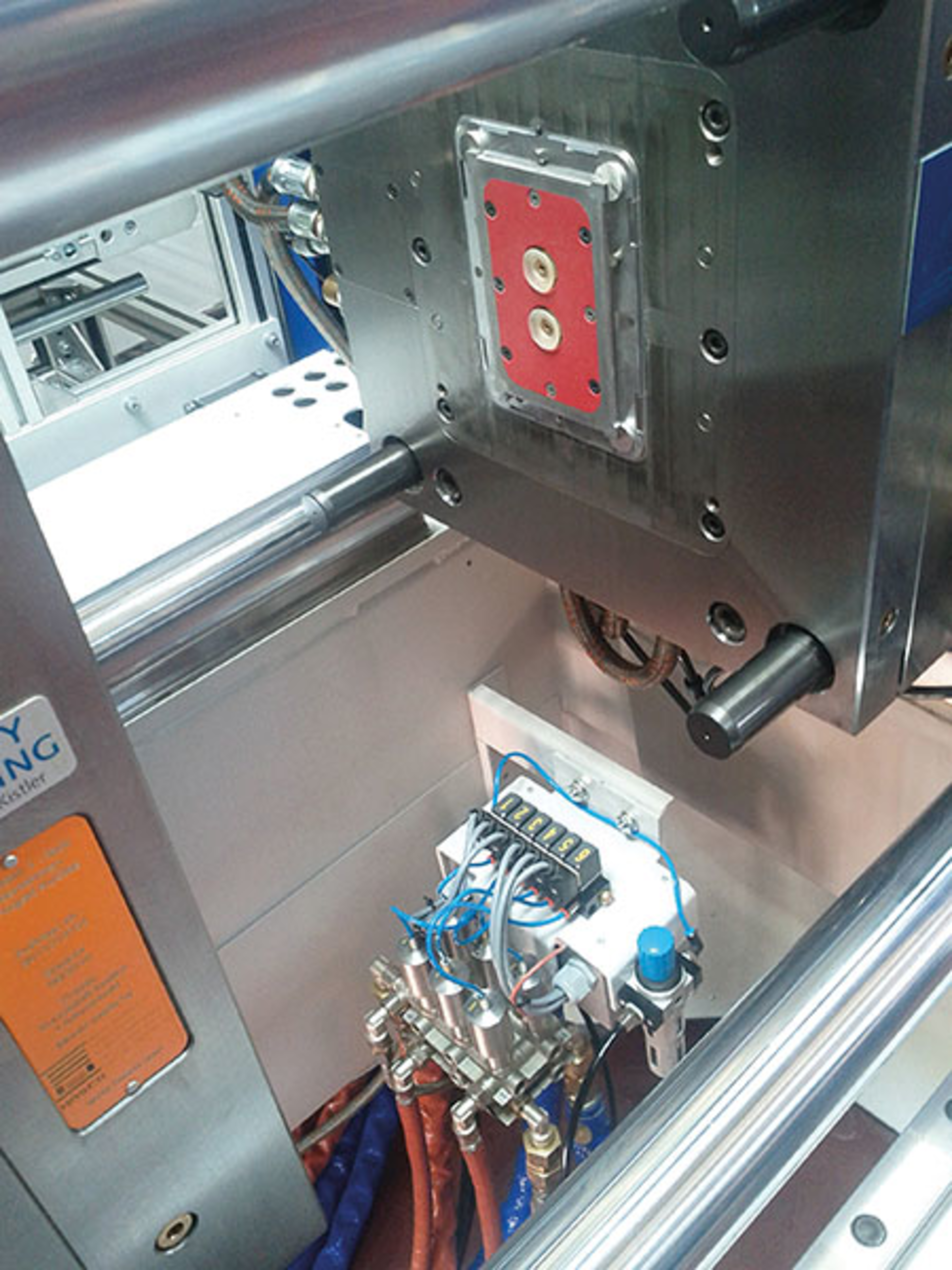 The Tempro manifold and Ball-Filled Mold with a part, in a molding press