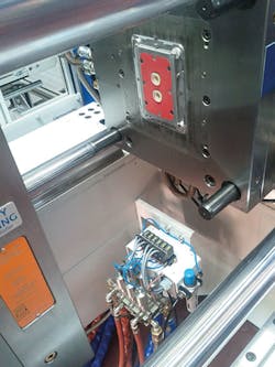 The Tempro manifold and Ball-Filled Mold with a part, in a molding press The Tempro manifold and Ball-Filled Mold with a part, in a molding press