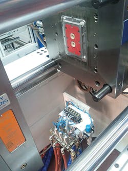 The Tempro manifold and Ball-Filled Mold with a part, in a molding press The Tempro manifold and Ball-Filled Mold with a part, in a molding press