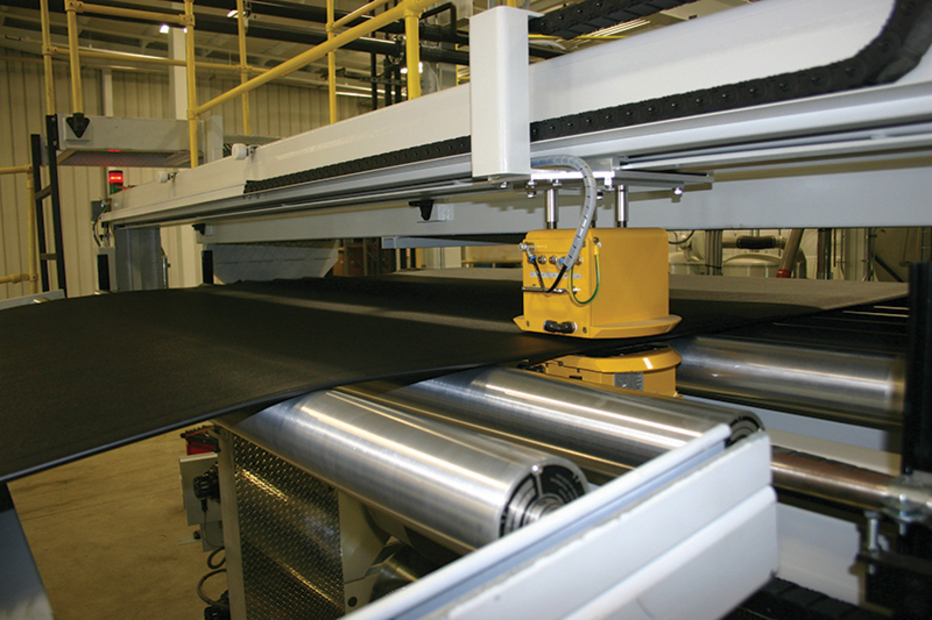 As The Beast extrudes TPO with a haircell finish, an &acirc;&euro;&oelig;isotope measurement system,&acirc;&euro; the yellow box, gauges the sheet.