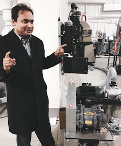 Biplab Pal of Prophecy Sensorlytics discusses his firm's 'wearable' sensor technology, seen here affixed to a blower on a vacuum pump.. Biplab Pal of Prophecy Sensorlytics discusses his firm's 'wearable' sensor technology, seen here affixed to a blower on a vacuum pump..