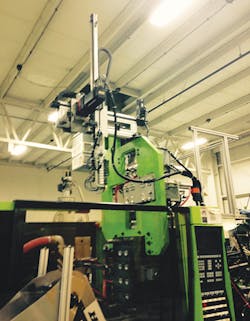 A robot is used in D&M's in-mold labeling process. The robot was customized for use on a 200-ton Engel horizontal press. A robot is used in D&M's in-mold labeling process. The robot was customized for use on a 200-ton Engel horizontal press.