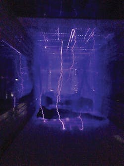 Looking into the tunnel of a Lectro Plastic Surface Treating System you can see plasma in action. Looking into the tunnel of a Lectro Plastic Surface Treating System you can see plasma in action.Â