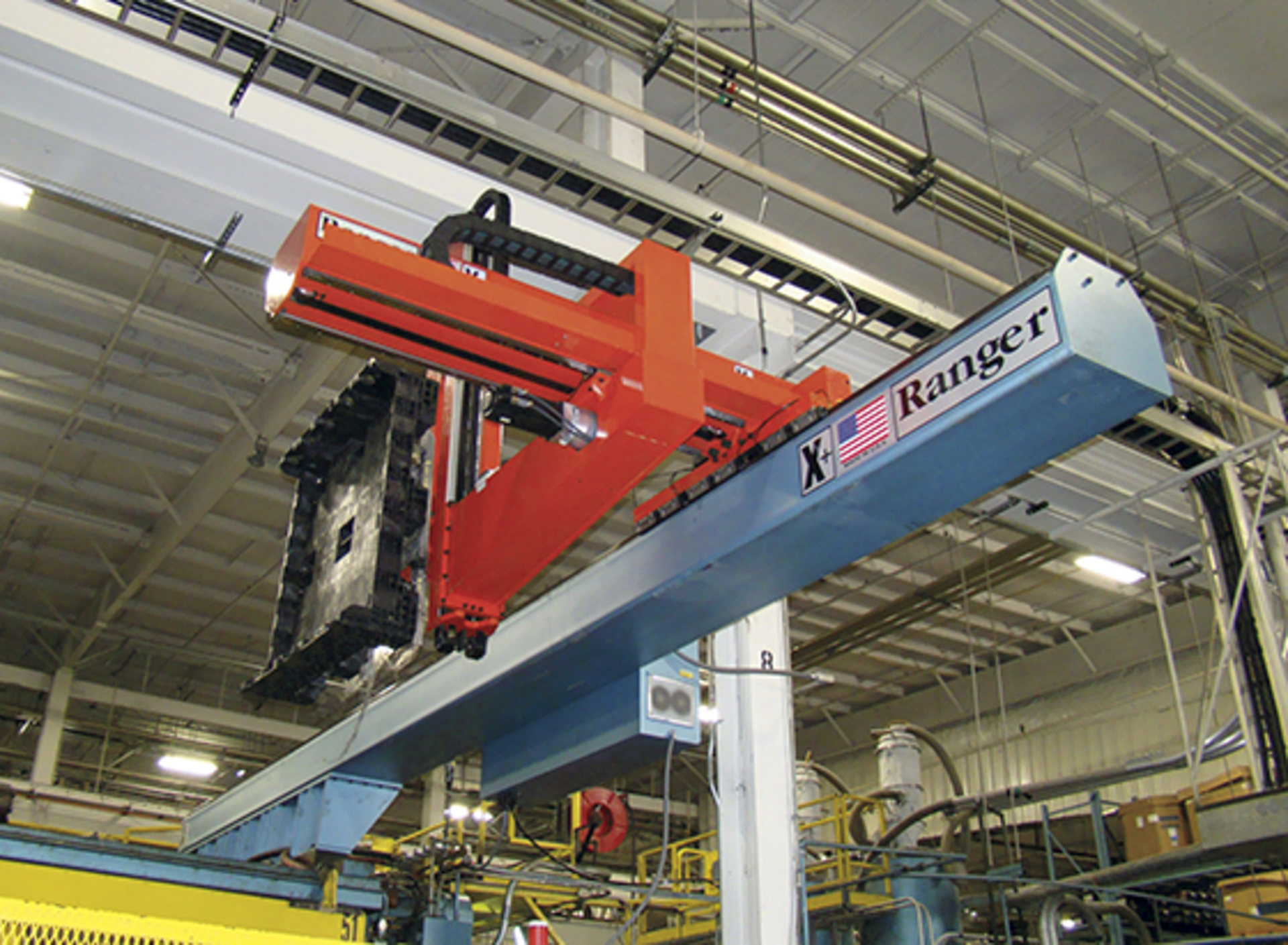A Ranger robot handles a shipping tote base.