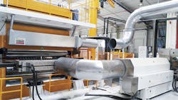 After being processed by a single-screw extruder, material enters an accumulator to increase its performance going into the die. After being processed by a single-screw extruder, material enters an accumulator to increase its performance going into the die.