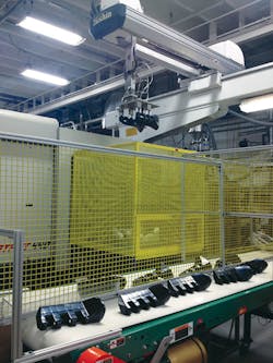 A Yushin Cartesian robot handles a wheel chock component at Venture's Newton Falls facility. A Yushin Cartesian robot handles a wheel chock component at Venture's Newton Falls facility.
