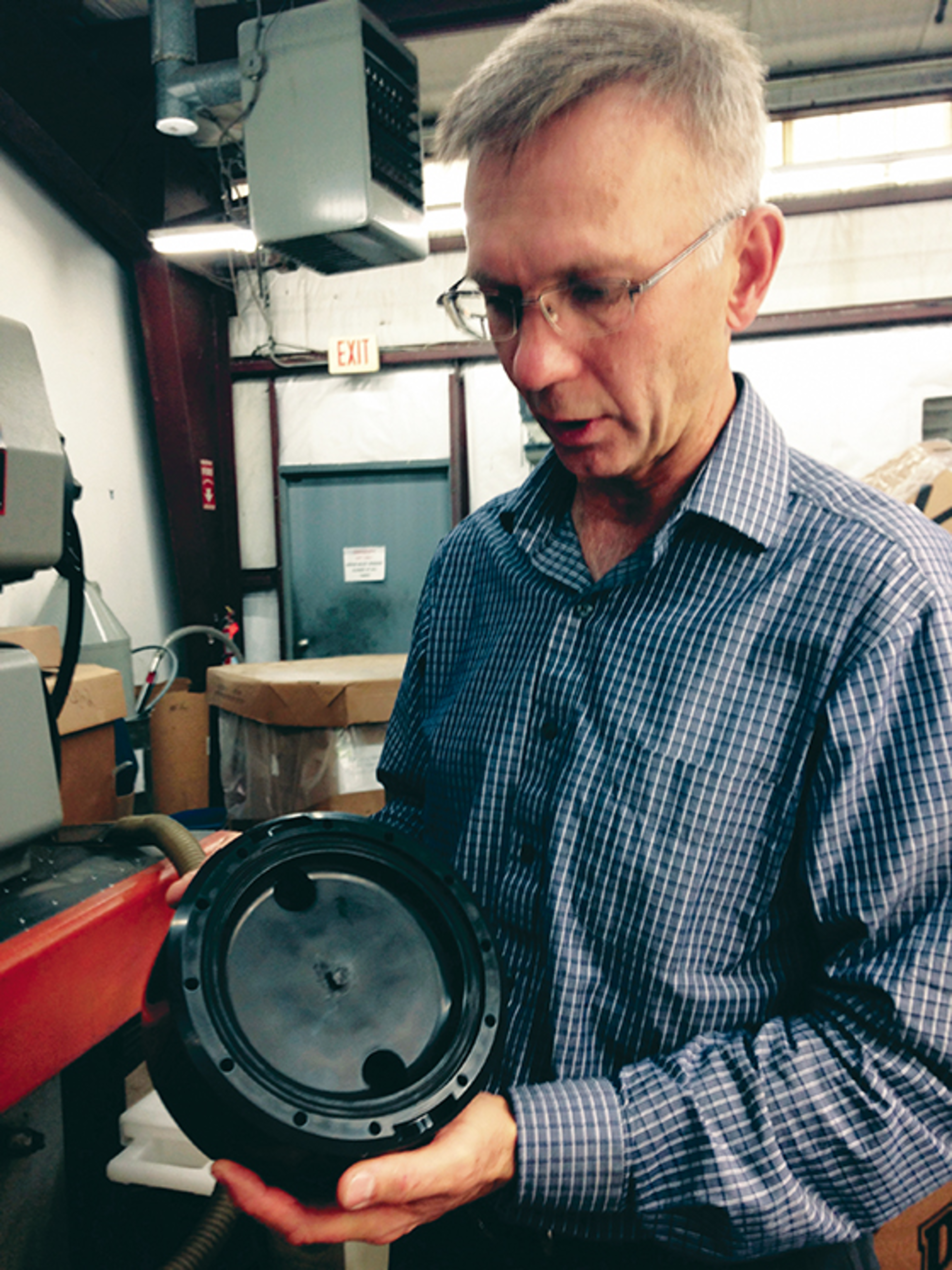 President Andy Molodetz holding a CY Plastics-produced part
