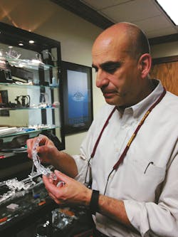 PRD Inc. President John Passanisi holds a lens for daytime running lights for a 2015 Camaro. PRD Inc. President John Passanisi holds a lens for daytime running lights for a 2015 Camaro.