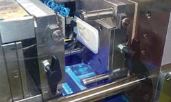 A 3-D-printed ABS insert is shown in a Boy injection molding machine. A 3-D-printed ABS insert is shown in a Boy injection molding machine.