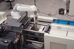 A TM Robotics six-axis robot works in conjunction with a Toshiba press A TM Robotics six-axis robot works in conjunction with a Toshiba press