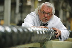 Tim Womer, president of TWWomer & Associates, examines a screw. Tim Womer, president of TWWomer & Associates, examines a screw.