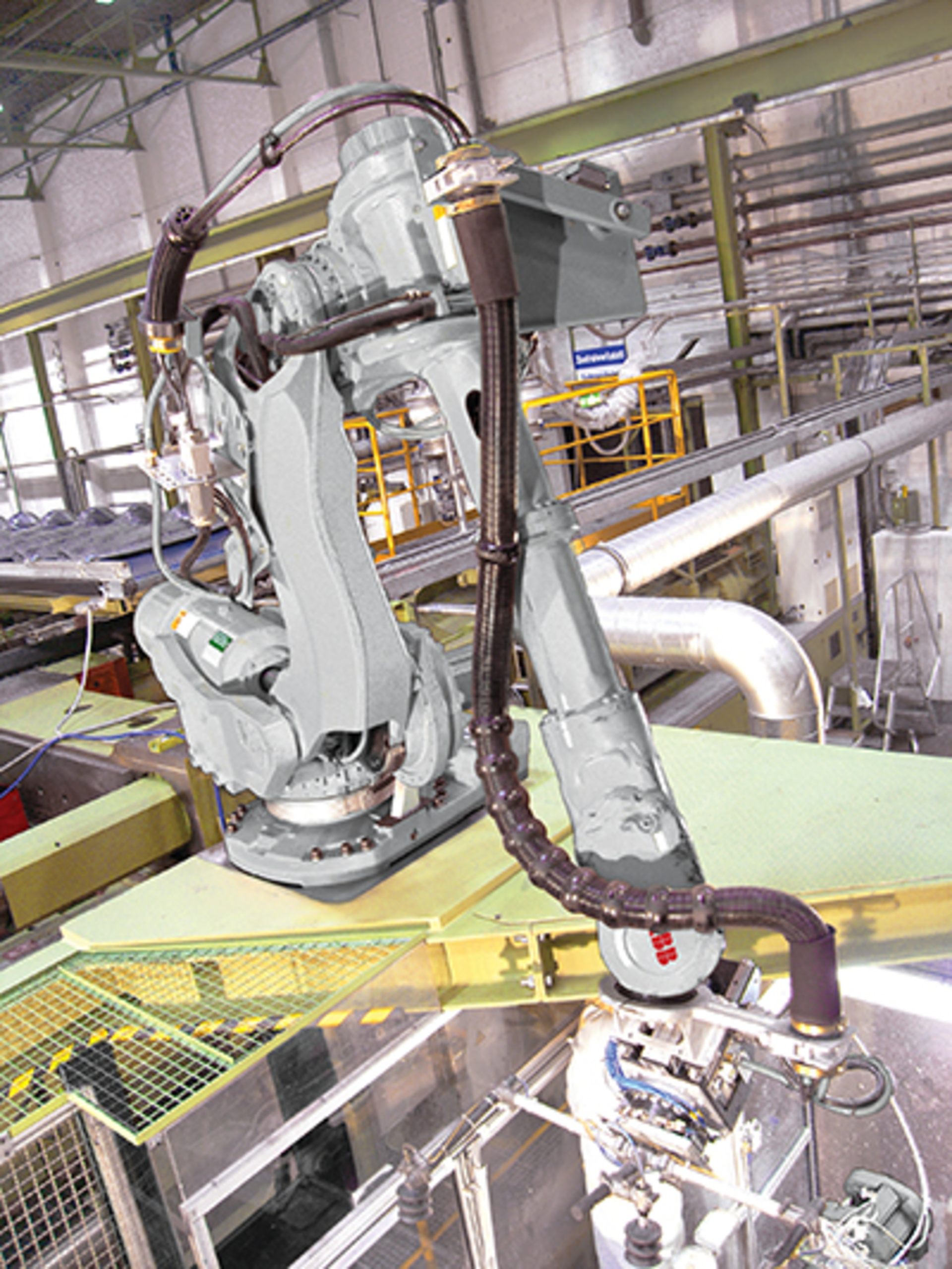 An ABB IRB 6650S shelf-mounted robot enables flexible handling of parts, as the robot can move around, rotate, and grasp the parts lying beneath it.