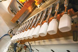 The IntelliDrive series, left, combines electric servomotors and hydraulics to make bottles, top right, faster and less expensively. The IntelliDrive series, left, combines electric servomotors and hydraulics to make bottles, top right, faster and less expensively.