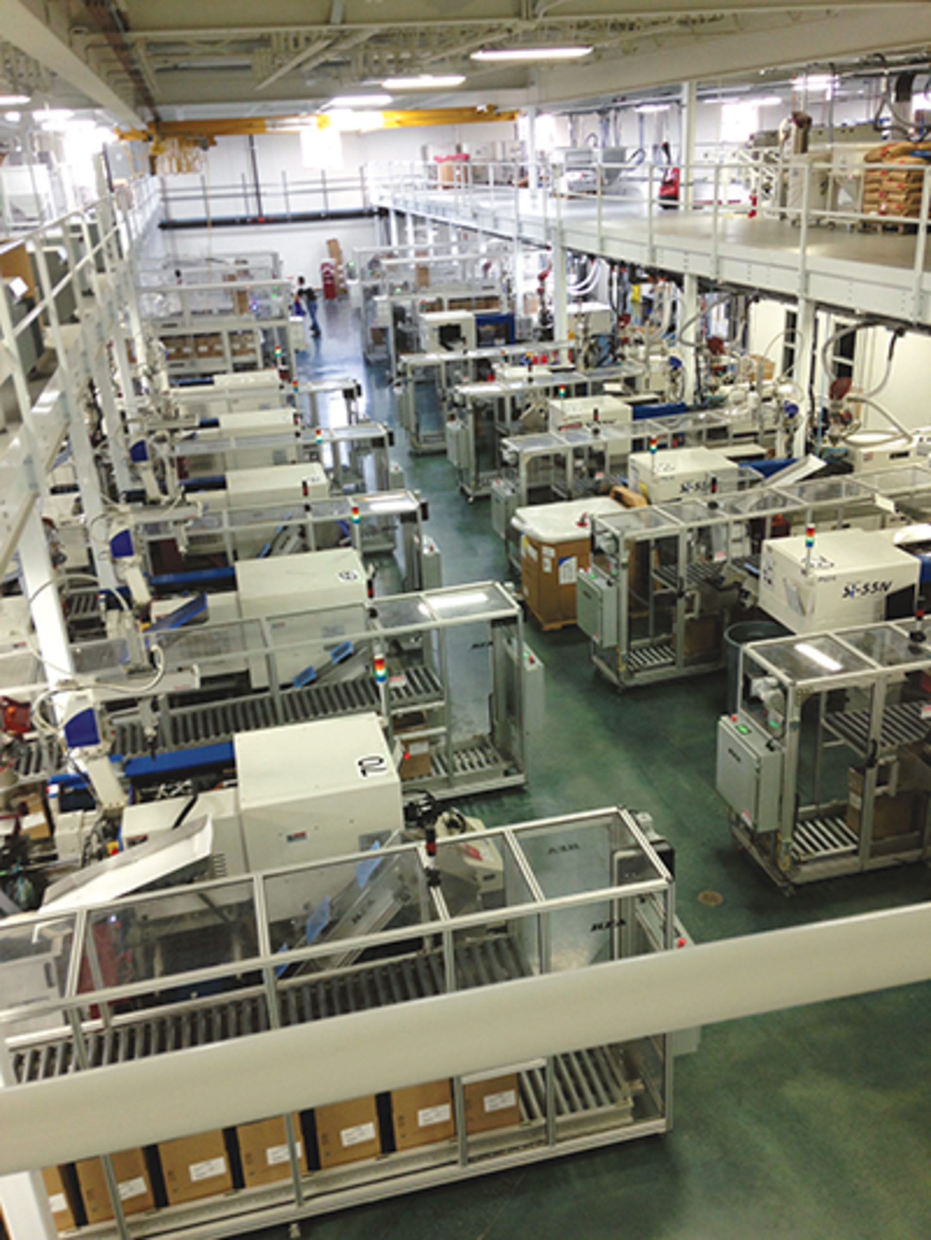 Toyo all-electric injection presses cover the plant floor while a mezzanine houses materials handling and provides a walking platform.