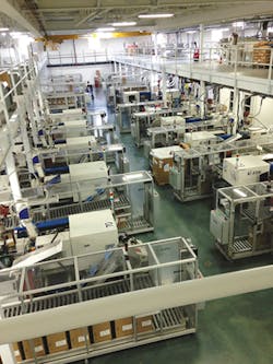 Toyo all-electric injection presses cover the plant floor while a mezzanine houses materials handling and provides a walking platform. Toyo all-electric injection presses cover the plant floor while a mezzanine houses materials handling and provides a walking platform.