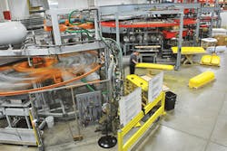 An operator works between MAAC’s three-station rotary thermoformers An operator works between MAAC’s three-station rotary thermoformers