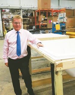 General Plastics President Bob Porsche stands alongside tables used for cooling parts after they have been formed. General Plastics President Bob Porsche stands alongside tables used for cooling parts after they have been formed.