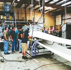 Bob Beckwith (second from left) and his team observe a Commodore PE extruder using a BEC die. Bob Beckwith (second from left) and his team observe a Commodore PE extruder using a BEC die.