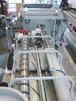 An overhead view of an Ettlinger injection molding machine. An overhead view of an Ettlinger injection molding machine.Â