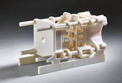 An Arburg Freeformer produced a toggle clamp model at the K show. An Arburg Freeformer produced a toggle clamp model at the K show.