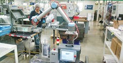 An employee works alongside a collaborative robot from Universal Robots USA Inc. An employee works alongside a collaborative robot from Universal Robots USA Inc.