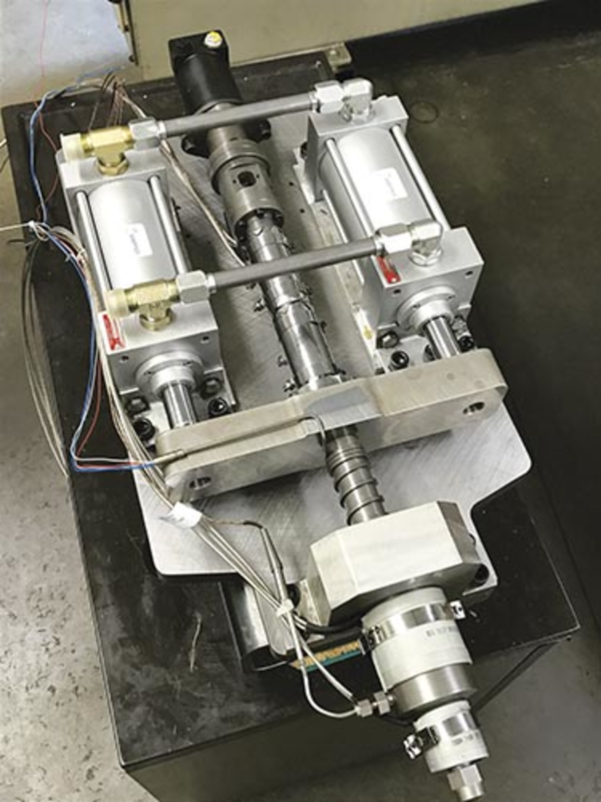 Top, the concept art for an electric version of the Inject-Ex. Bottom, a hydraulic version of the Inject-Ex installed on an injection press at Md Plastics.