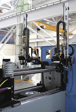Two robots for parts handling are fully integrated into the machine, allowing for post-mold operations on both sides of the cube within a machine width of only 7 feet. Two robots for parts handling are fully integrated into the machine, allowing for post-mold operations on both sides of the cube within a machine width of only 7 feet.