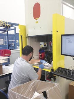 A worker performs laser engraving at PTI. A worker performs laser engraving at PTI.