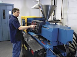 An operator performs quality-control testing of compounds on a Boy Machine. An operator performs quality-control testing of compounds on a Boy Machine.