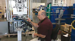 A technician works on a robot integration project at Sepro America.