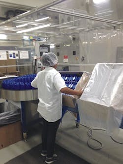 An Arch Plastics Packaging employee packs up bottles produced at the plant.