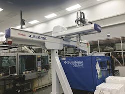 A Yushin CT robot arranged to drop parts at the end of the machine A Yushin CT robot arranged to drop parts at the end of the machine