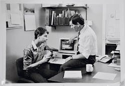 Don Paulson reviews the latest computer-based courseware with developer and son Scott Paulson, circa 1980.
