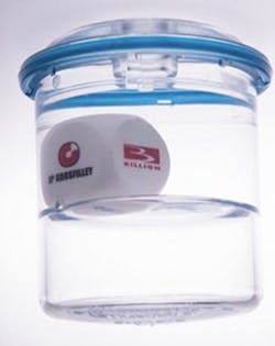 A sealed cup containing a six-sided die bobbing in water A sealed cup containing a six-sided die bobbing in water