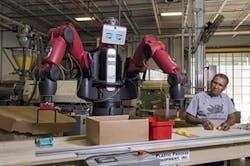 An employee works alongside a Baxter cobot from Rethink Robotics. An employee works alongside a Baxter cobot from Rethink Robotics.