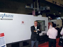 Peter Gardner of Daiichi Jitsugyo (America) Inc. with an MD350S8000 injection molding machine. The press includes a toggle-clamp system that delivers high-speed mold opening and closing actions. Peter Gardner of Daiichi Jitsugyo (America) Inc. with an MD350S8000 injection molding machine. The press includes a toggle-clamp system that delivers high-speed mold opening and closing actions.