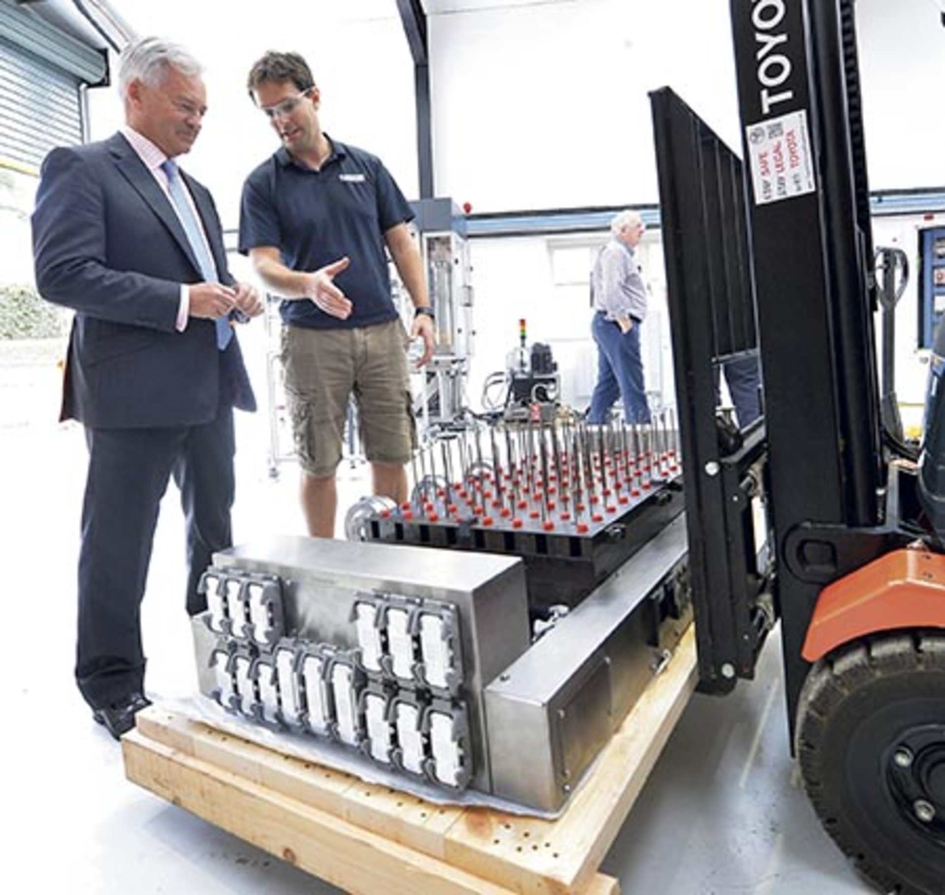 U.K. Government Minister Sir Alan Duncan MP, left, and Surface Generation's Ben Halford discuss a PtFS mold base at the company's facility in Rutland, U.K.