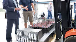 U.K. Government Minister Sir Alan Duncan MP, left, and Surface Generation's Ben Halford discuss a PtFS mold base at the company's facility in Rutland, U.K.
