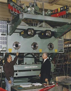 Bob Ackley, right, and assembly technician Ken Perreault review the final assembly of a Davis-Standard seven-layer Flat Pak system, which is used in the bottle blow molding industry.