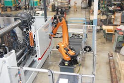 The Negri Bossi Bi-Power injection molding machine is integrated with a Kuka six-axis robot and a conveyor./PMM The Negri Bossi Bi-Power injection molding machine is integrated with a Kuka six-axis robot and a conveyor./PMM