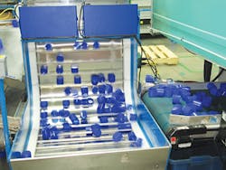 Cobra-produced caps roll off a conveyor/PMM Cobra-produced caps roll off a conveyor/PMM