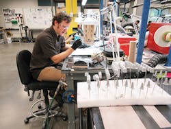 A Protolabs employee checks clear parts. All parts are checked and hand finished if needed before shipping./PMM A Protolabs employee checks clear parts. All parts are checked and hand finished if needed before shipping./PMM