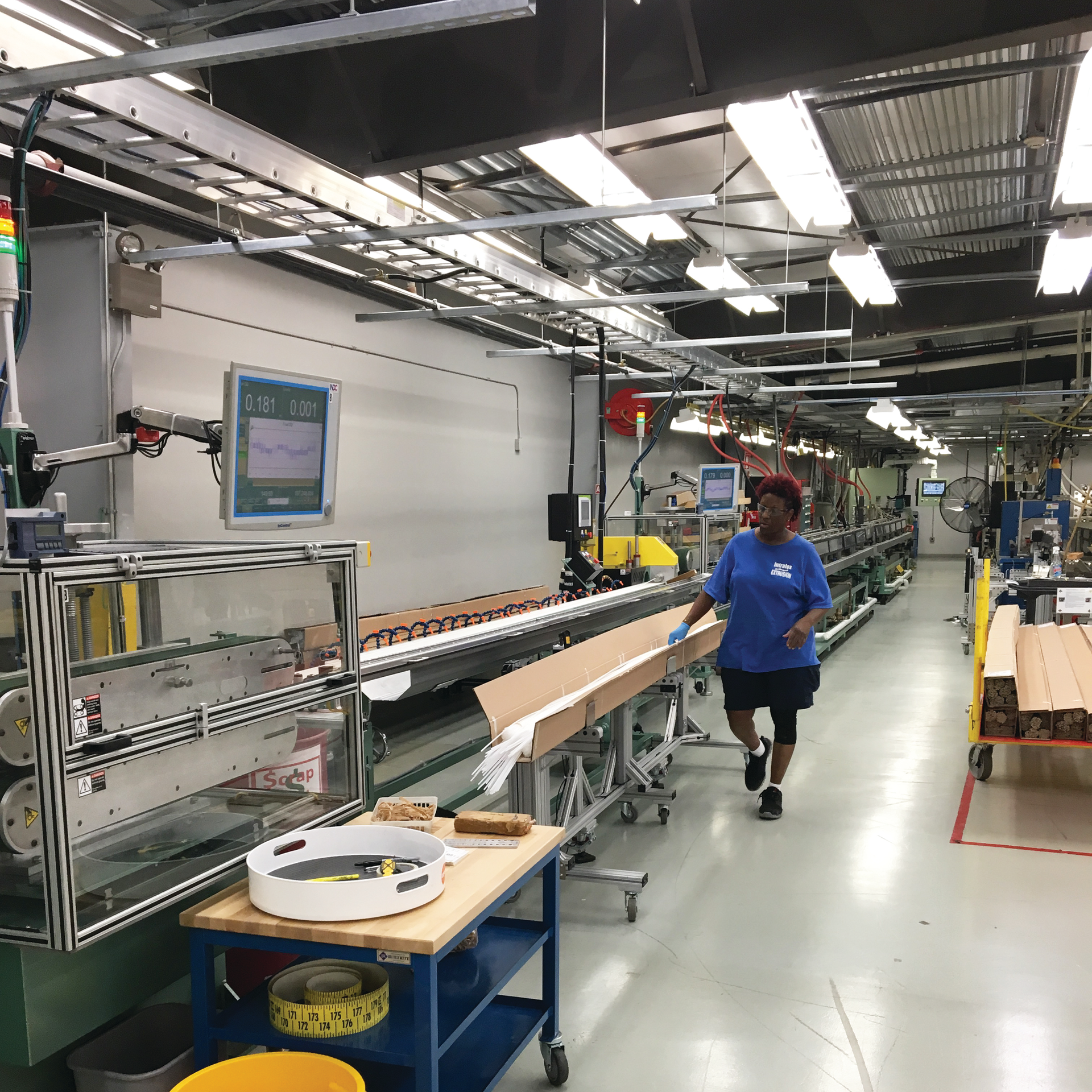 An employee packs rods produced by Intralox&rsquo;s new dual-strand profile extrusion line, installed by Davis-Standard.