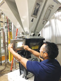 Select Plastics recently added three Process Control gravimetric batch blenders. Right, an employee checks out a blender. Select Plastics recently added three Process Control gravimetric batch blenders. Right, an employee checks out a blender.