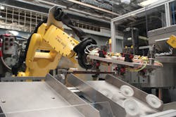 A Fanuc robotic arm handles gears. A Fanuc robotic arm handles gears.