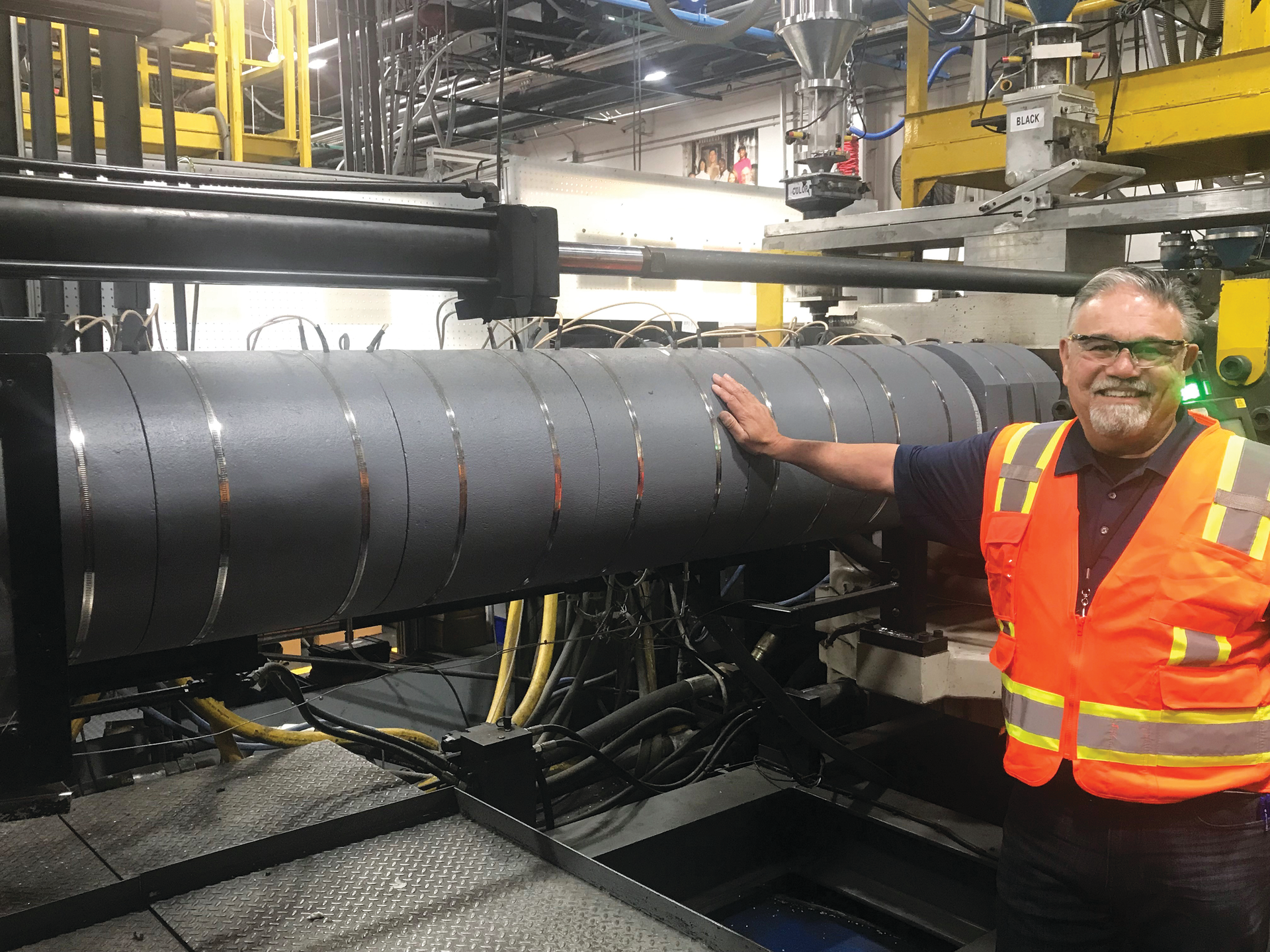 Pelican Products&rsquo; Gabe Guerra touches a TCS radiant heater to illustrate its safety. Doing this on a traditional heater band would cause a severe burn.