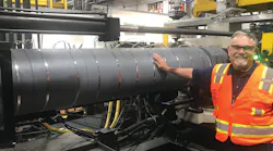 Pelican Products’ Gabe Guerra touches a TCS radiant heater to illustrate its safety. Doing this on a traditional heater band would cause a severe burn.