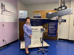 Yushin President Mayumi Kotani stands by the FRA robot, which won awards in Japan and Germany for technology, machine design and energy efficiency.