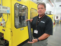 Bob Renfrew, manager of accessories production, holds a tube used on a blower that was blow molded on a Bekum machine. Bob Renfrew, manager of accessories production, holds a tube used on a blower that was blow molded on a Bekum machine.