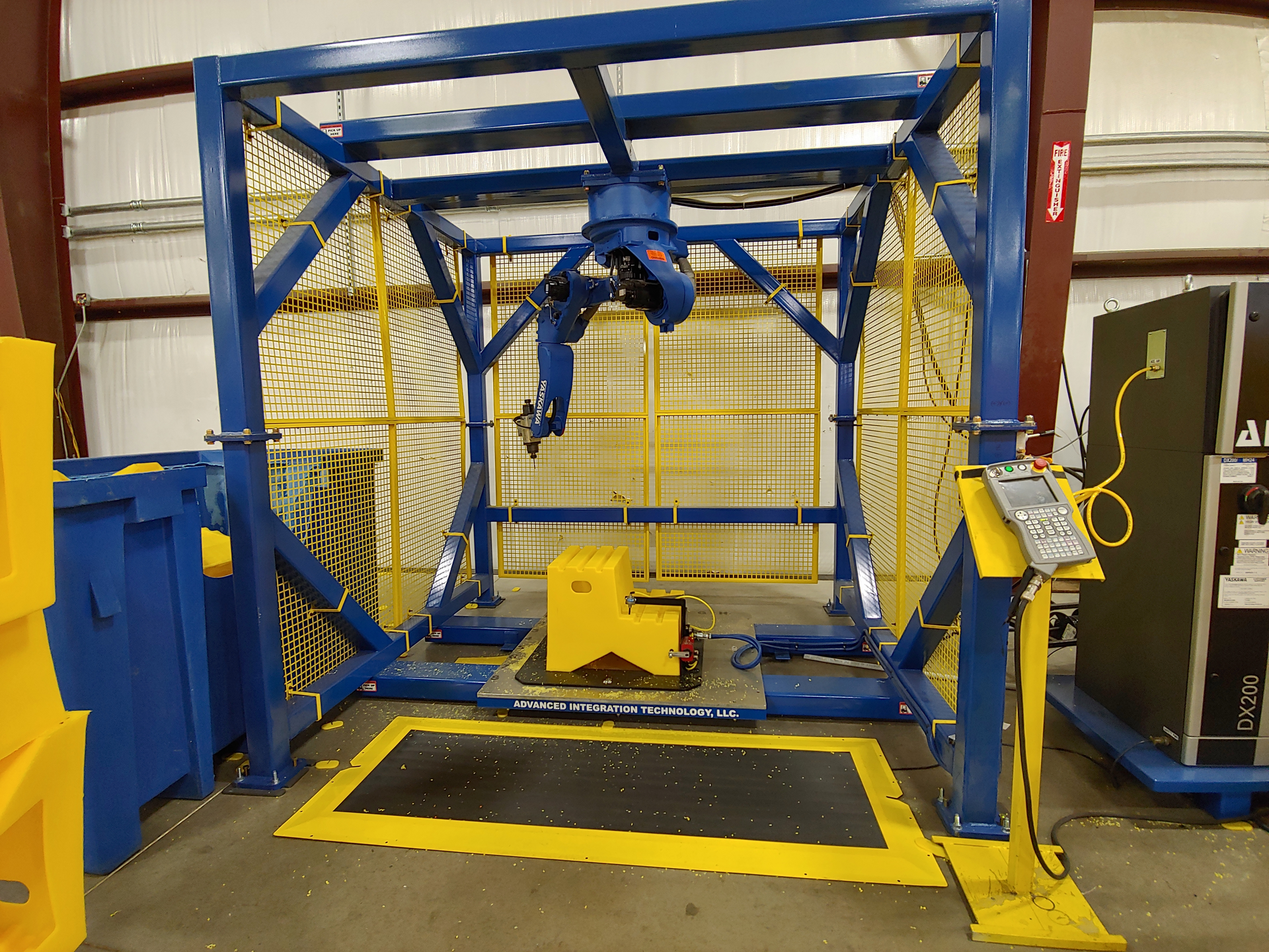 The Yaskawa robot arm and custom fixture from RLR, formerly known as Advanced Integration Technology LLC, simplified the process of cutting rotomolded steps at Diversified Plastics' factory.